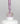 Nahaufnahme einer offenen Longlife UV-Lack Dreamland Flasche. Die Farbe ist ein helles Violett. Der UV-Nagellack tropft am Pinsel herunter.