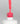 Nahaufnahme einer offenen Longlife UV-Lack Feminista Flasche. Die Farbe ist ein knalliges Pink mit hoher Sättigung. Der UV-Nagellack tropft am Pinsel herunter.