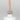 Nahaufnahme einer offenen Longlife UV-Lack Light Nude Flasche. Die Farbe ist ein helles Nude. Der UV-Nagellack tropft am Pinsel herunter.