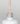 Nahaufnahme einer offenen Longlife UV-Lack Mademoiselle Flasche. Die Farbe ist ein helles Nude. Der UV-Nagellack tropft am Pinsel herunter.