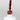 Nahaufnahme einer offenen Longlife UV-Lack Marsala Flasche. Die Farbe ist ein dunkles Rot mit Braun-Stich. Der UV-Nagellack tropft am Pinsel herunter.