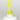 Nahaufnahme einer offenen Longlife UV-Lack Neon Lemon Flasche. Die Farbe ist ein knalliges Gelb mit hoher Sättigung. Der UV-Lack tropft am Pinsel herunter.