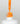 Nahaufnahme einer offenen Longlife UV-Lack Neon Mandarine Flasche. Die Farbe ist ein knalliges Orange mit hoher Sättigung. Der UV-Lack tropft am Pinsel herunter.