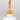 Nahaufnahme einer offenen Longlife UV-Lack Neon Mandarine Flasche. Die Farbe ist ein knalliges Orange mit hoher Sättigung. Der UV-Lack tropft am Pinsel herunter.