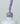 Nahaufnahme einer offenen Longlife UV-Lack Paradise Flasche. Die Farbe ist ein helles Violett mit niedriger Sättigung. Der UV-Lack tropft am Pinsel herunter.
