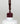 Nahaufnahme einer offenen Longlife UV-Lack Rouge Noir Flasche. Die Farbe ist ein dunkles Rot mit leichtem Braunstich. Der UV-Lack tropft am Pinsel herunter.