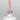 Nahaufnahme einer Longlife UV-Lack Spirit Flasche. Die Farbe ist ein helles Nude. Der UV-Lack tropft am Pinsel herunter.