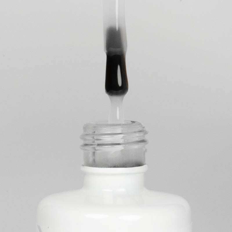 Nahaufnahme einer offenen Longlife UV-Lack Make it Matt Flasche. Die Farbe ist transparent doch leicht milchig. Der UV-Nagellack tropft am Pinsel herunter.
